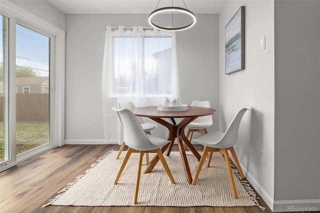 13438 E 13th Pl, Aurora, CO 80011 - dining space with baseboards, plenty of natural light, and wood finished floors