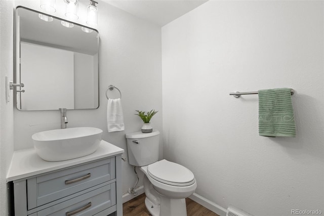 13438 E 13th Pl, Aurora, CO 80011 - bathroom with vanity, baseboards, toilet, and wood finished floors