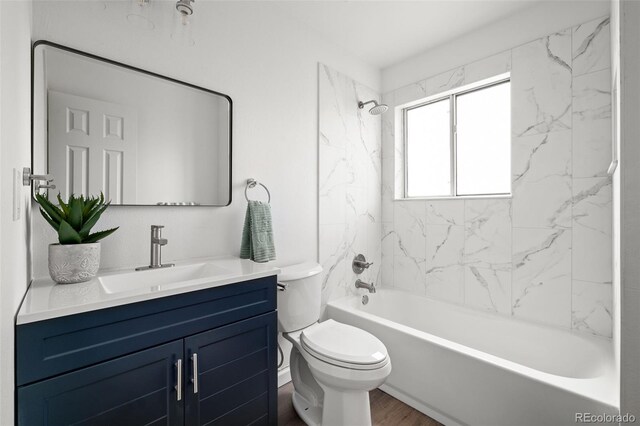 13438 E 13th Pl, Aurora, CO 80011 - full bathroom featuring toilet, shower / tub combination, wood finished floors, and vanity