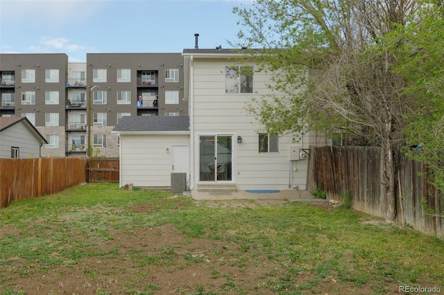 13438 E 13th Pl, Aurora, CO 80011 - back of house with entry steps, central AC unit, a lawn, and a fenced backyard