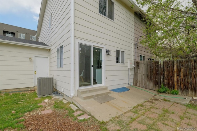 13438 E 13th Pl, Aurora, CO 80011 - rear view of house featuring entry steps, fence, a patio, and central AC
