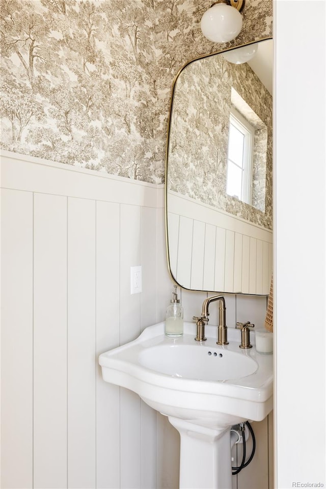 4131 Quivas St, Denver, CO 80211 - bathroom featuring a wainscoted wall, wallpapered walls, and a decorative wall
