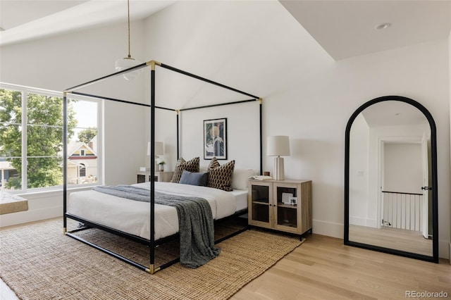 4131 Quivas St, Denver, CO 80211 - bedroom with light wood-type flooring, high vaulted ceiling, and arched walkways