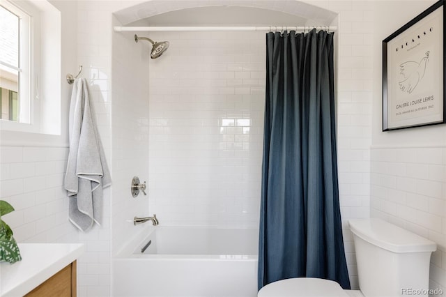 4131 Quivas St, Denver, CO 80211 - bathroom featuring tile walls, vanity, and shower / bathtub combination with curtain