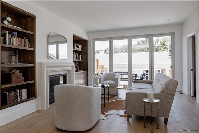 4131 Quivas St, Denver, CO 80211 - living room with a glass covered fireplace, healthy amount of natural light, built in features, and wood finished floors
