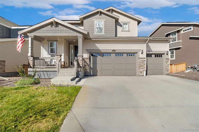 craftsman-style house with a porch, a garage, and a front yard