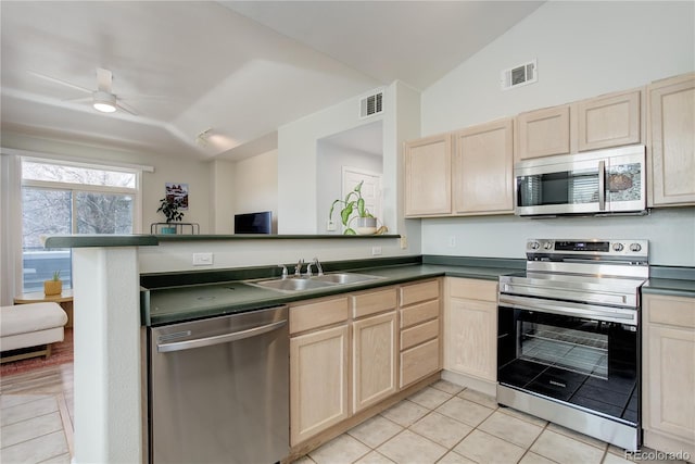 kitchen featuring a sink, light brown cabinetry, stainless steel appliances, and visible vents