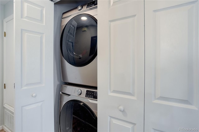 clothes washing area with laundry area and stacked washer / drying machine