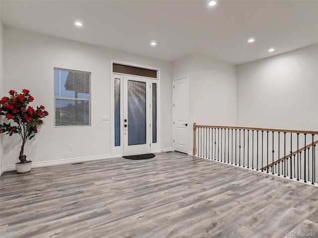 foyer featuring recessed lighting, wood finished floors, and baseboards