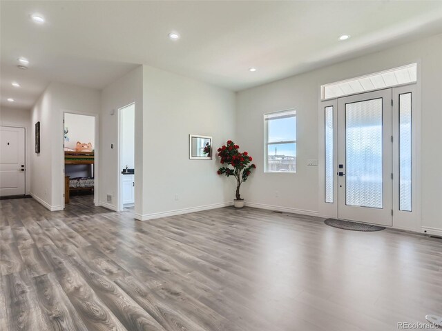 foyer with recessed lighting, baseboards, and wood finished floors