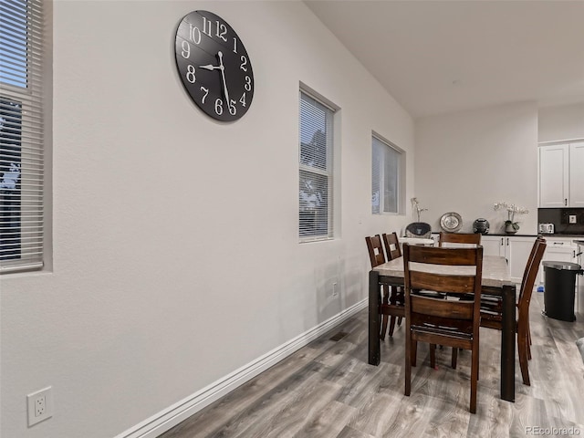 dining room featuring baseboards and wood finished floors