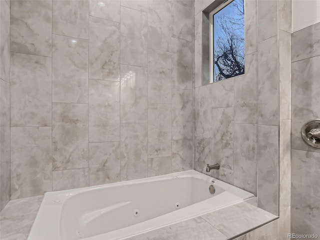 full bath with walk in shower, tile walls, and a jetted tub