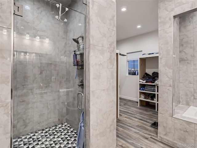 full bathroom with recessed lighting, a shower stall, and wood finished floors