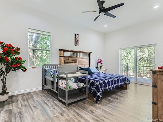 bedroom with access to exterior, recessed lighting, baseboards, and wood finished floors