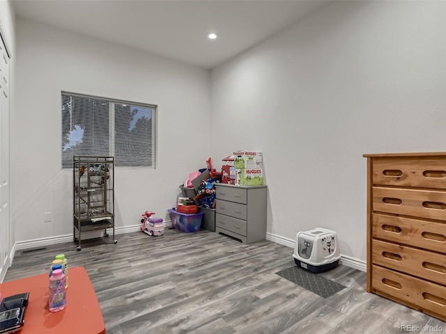 game room featuring recessed lighting, baseboards, and wood finished floors