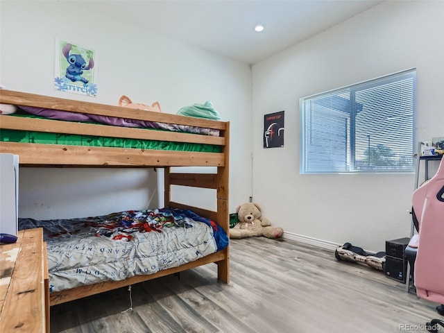 bedroom with recessed lighting, baseboards, and wood finished floors