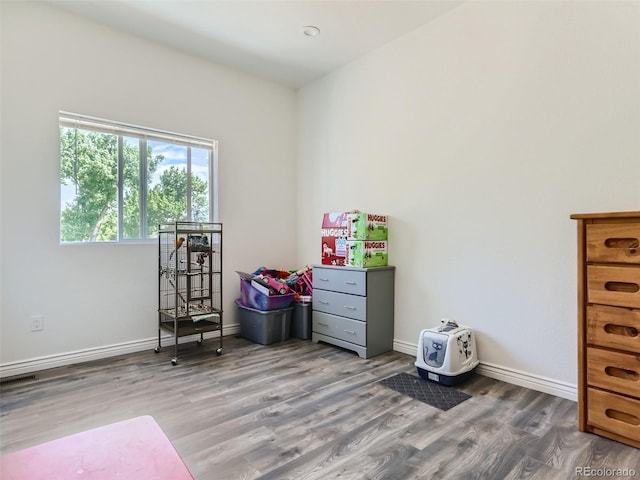 interior space featuring visible vents, wood finished floors, and baseboards