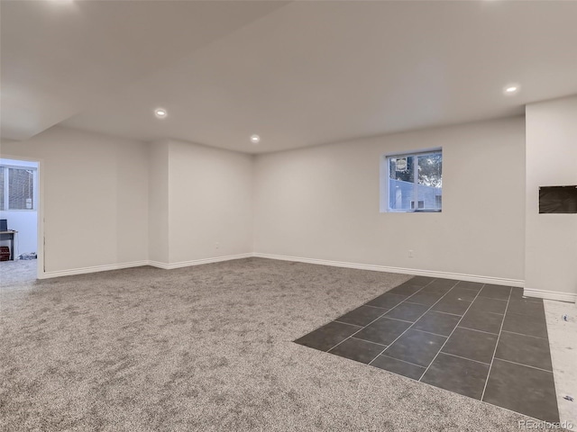 basement with recessed lighting, baseboards, and dark colored carpet