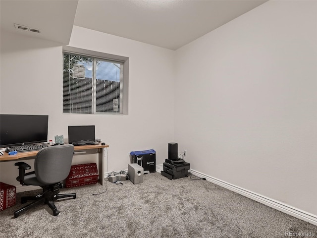 carpeted office space featuring visible vents and baseboards