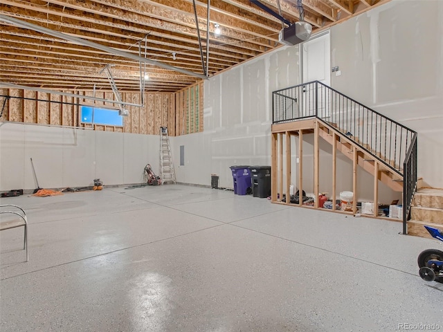 basement featuring stairway and a garage