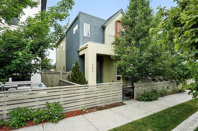 1376 Snowberry Ln, Louisville, CO 80027 - view of front of home with a gate, a fenced front yard, and stucco siding