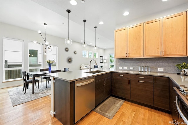 1376 Snowberry Ln, Louisville, CO 80027 - kitchen with stainless steel dishwasher, a peninsula, recessed lighting, backsplash, and light wood-style floors
