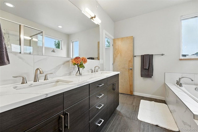 1376 Snowberry Ln, Louisville, CO 80027 - bathroom with double vanity, wood finished floors, a bath, and recessed lighting