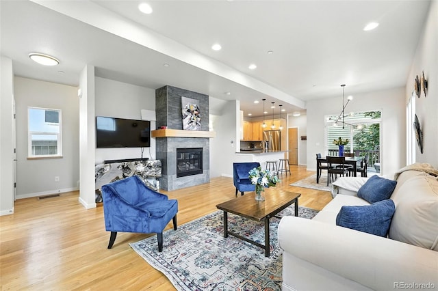 1376 Snowberry Ln, Louisville, CO 80027 - living area with light wood finished floors, a fireplace, recessed lighting, and a chandelier