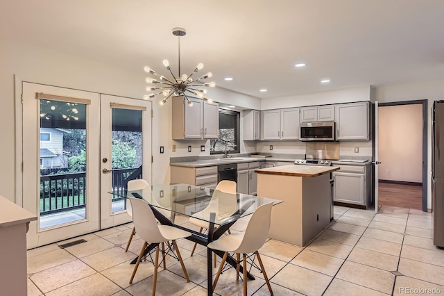 kitchen featuring appliances with stainless steel finishes, wooden counters, gray cabinetry, light tile patterned flooring, and recessed lighting