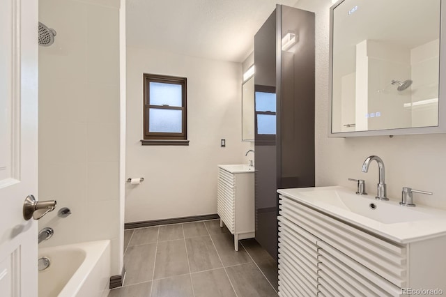 full bathroom featuring two vanities, tile patterned floors, baseboards, and tub / shower combination