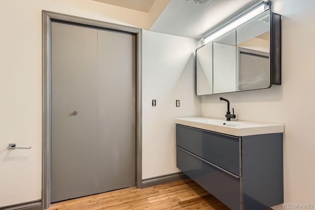 bathroom featuring wood finished floors and vanity