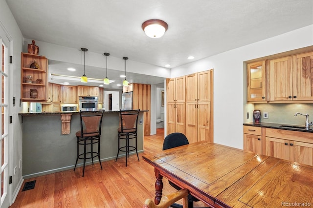 dining space featuring sink and light hardwood / wood-style flooring