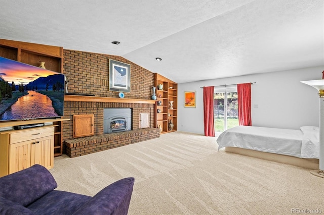 carpeted bedroom with a textured ceiling, lofted ceiling, a brick fireplace, and access to exterior