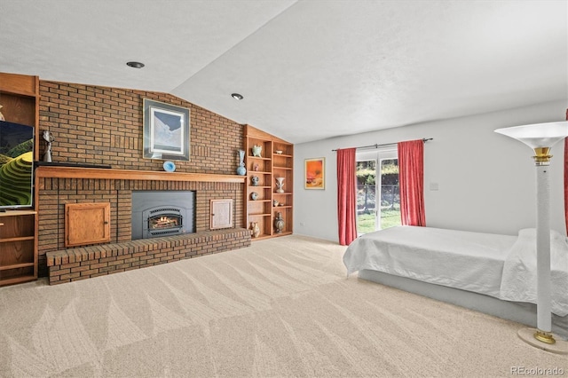 bedroom featuring vaulted ceiling, a brick fireplace, and carpet flooring