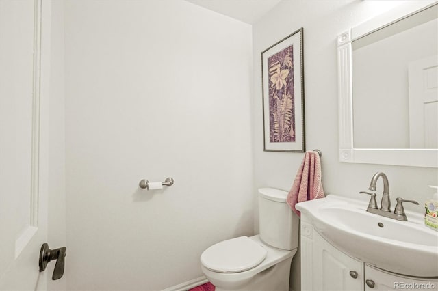 bathroom featuring toilet and vanity