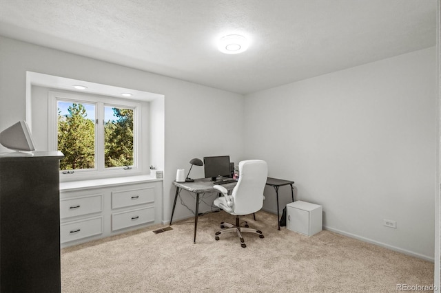 office space featuring a textured ceiling and light colored carpet