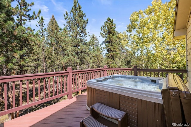 wooden deck with a hot tub