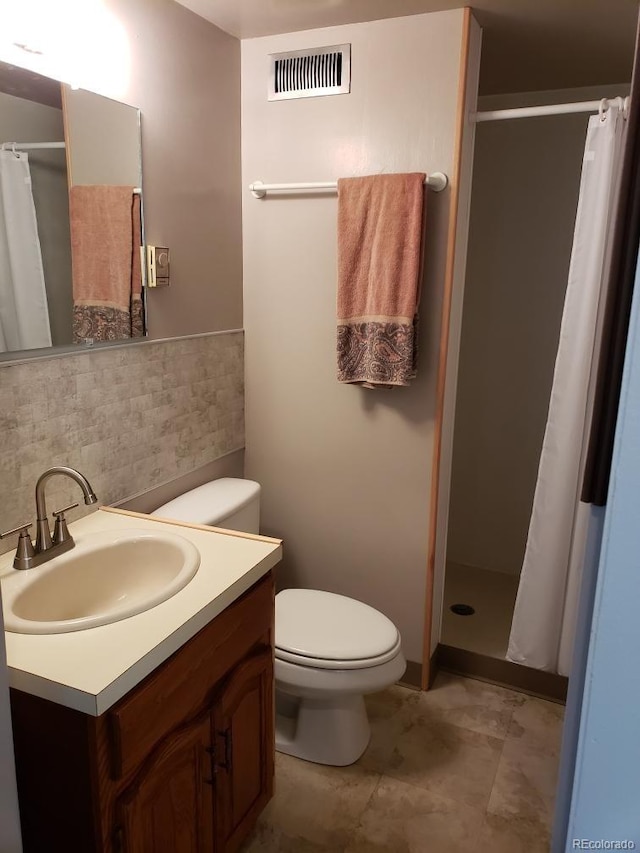 bathroom with vanity, toilet, and walk in shower