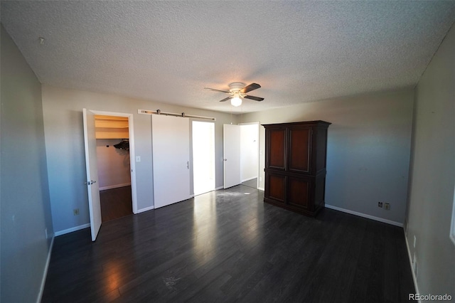 unfurnished bedroom featuring a textured ceiling, dark hardwood / wood-style flooring, and ceiling fan