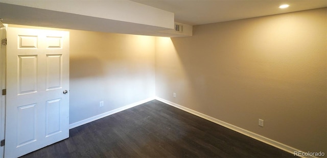 basement with dark hardwood / wood-style floors