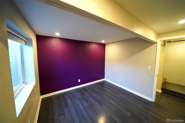 unfurnished room featuring dark hardwood / wood-style floors and plenty of natural light