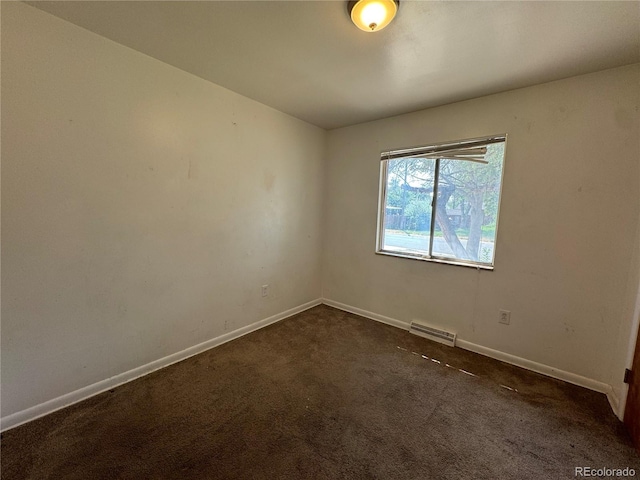 empty room featuring dark colored carpet