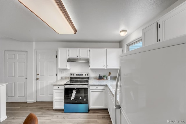 8479 Rabbitbrush Way, Parker, CO 80134 - kitchen featuring electric range, refrigerator, under cabinet range hood, and white cabinets