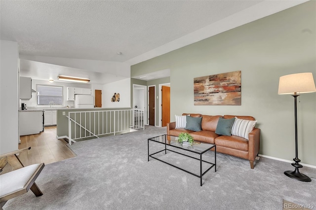 8479 Rabbitbrush Way, Parker, CO 80134 - living area with light carpet, a textured ceiling, and vaulted ceiling