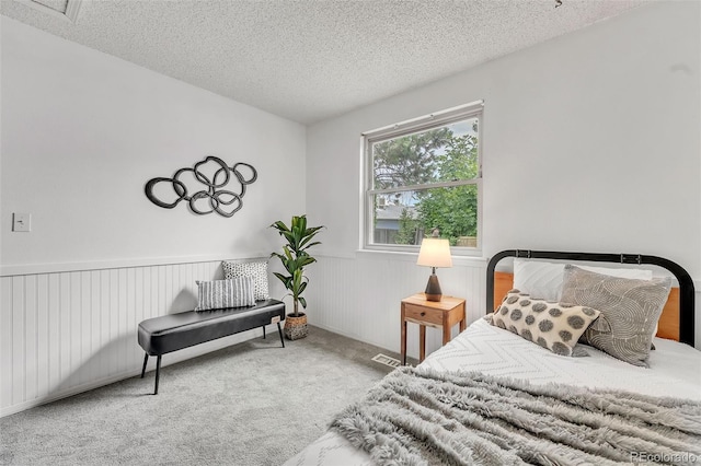 8479 Rabbitbrush Way, Parker, CO 80134 - carpeted bedroom featuring a textured ceiling and a wainscoted wall