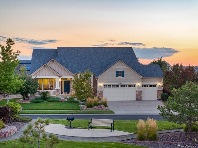 27235 E Lakeview Pl, Aurora, CO 80016 - craftsman-style house featuring a front yard, an attached garage, driveway, and stone siding