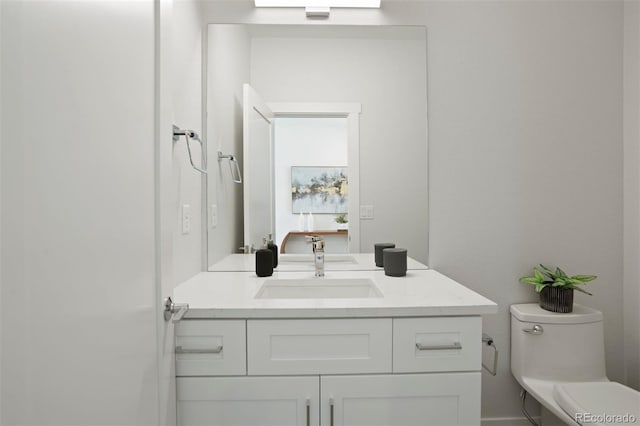 half bath featuring toilet and vanity