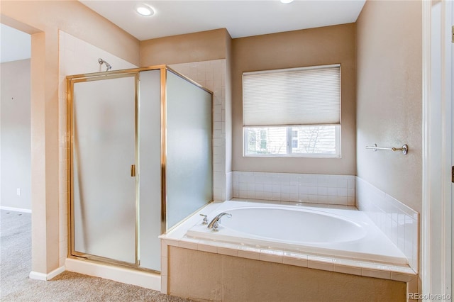 bathroom featuring a bath and a stall shower