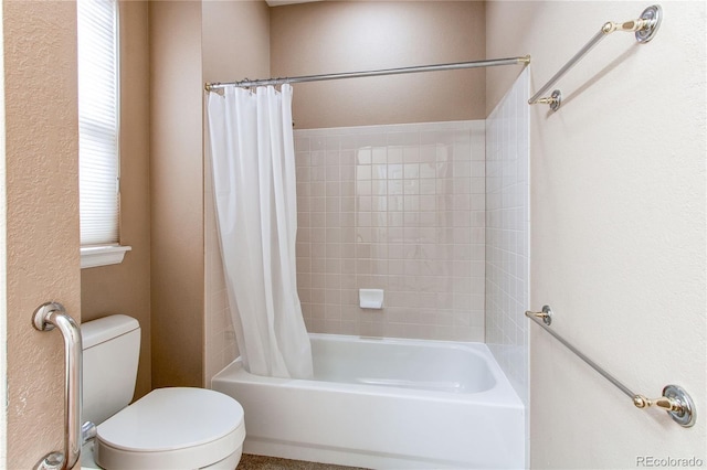 full bathroom featuring shower / tub combo with curtain and toilet