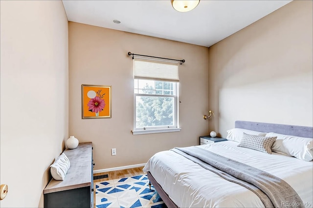 bedroom featuring light wood-type flooring and baseboards